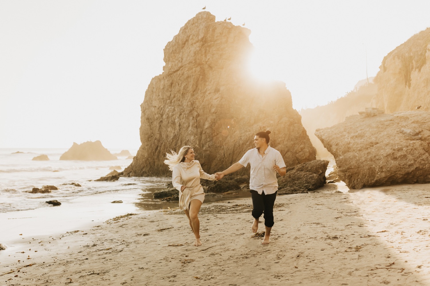 couple running on a beach in malibu