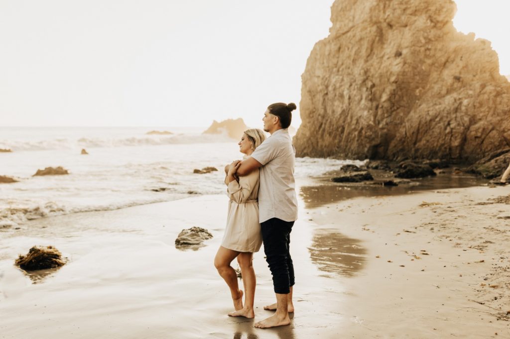 couple looking at the ocean at el matador state beach in malibu