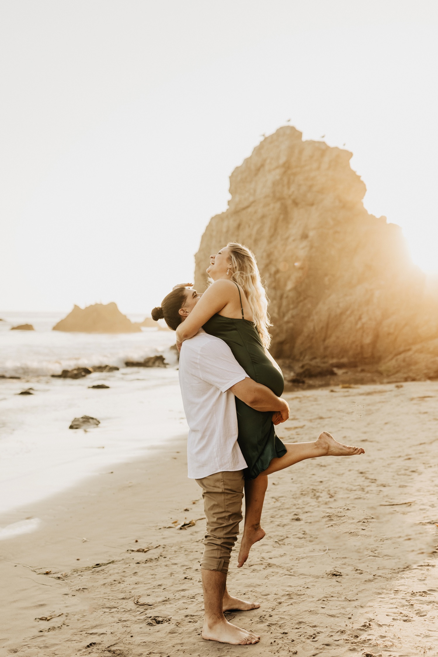 guy picking up girl on beach in malibu